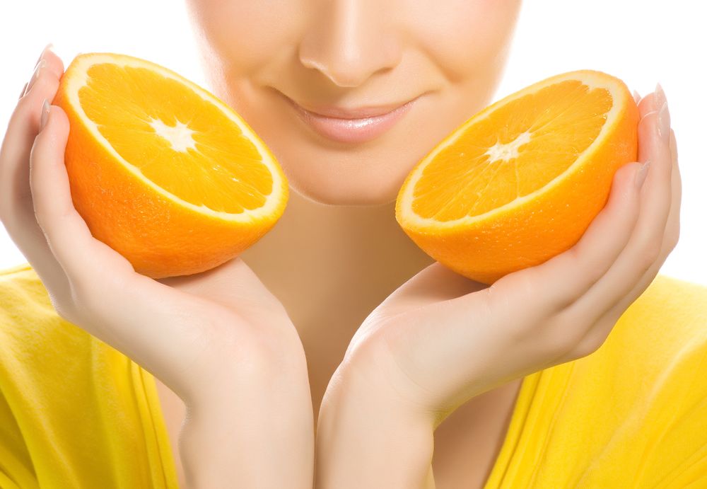 Beautiful girl with juicy orange